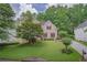Traditional two-story brick home with a well-kept lawn and mature trees in a serene setting at 7071 Glen Cove Ln, Stone Mountain, GA 30087