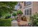 Well-maintained brick home exterior with mature trees, lush bushes, and manicured gardens at 7071 Glen Cove Ln, Stone Mountain, GA 30087