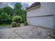 Attached two-car garage with a paved driveway at 7071 Glen Cove Ln, Stone Mountain, GA 30087