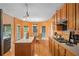 Well-lit kitchen featuring wood cabinets, island, and modern appliances, with hardwood floors at 7071 Glen Cove Ln, Stone Mountain, GA 30087
