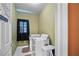 Functional laundry room with washer, dryer, and storage space, plus a small window at 7071 Glen Cove Ln, Stone Mountain, GA 30087