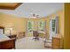 Bright main bedroom area with desk, chair, and large windows overlooking the yard at 7071 Glen Cove Ln, Stone Mountain, GA 30087