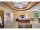 Comfortable main bedroom with walk-in closet, ceiling fan, and bedside table at 7071 Glen Cove Ln, Stone Mountain, GA 30087