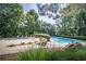 Community pool area with lounge chairs and landscaping at 7071 Glen Cove Ln, Stone Mountain, GA 30087