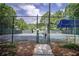 Fenced-in community tennis court with a bench at 7071 Glen Cove Ln, Stone Mountain, GA 30087
