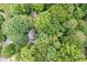 Aerial view of a home nestled among mature trees, offering privacy and a tranquil setting at 735 Wood Valley Trce, Roswell, GA 30076