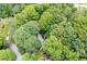 Aerial view of a secluded home nestled among lush trees in a peaceful, wooded neighborhood at 735 Wood Valley Trce, Roswell, GA 30076