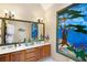 Bathroom featuring unique stained glass window, soaking tub, and double sinks at 735 Wood Valley Trce, Roswell, GA 30076