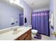 Bathroom with purple shower curtain, white toilet, and white countertop at 735 Wood Valley Trce, Roswell, GA 30076