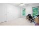 Bright bedroom with carpeting, neutral walls, and window views to the exterior yard at 735 Wood Valley Trce, Roswell, GA 30076