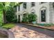 Long driveway leading to home with arched windows and manicured bushes at 735 Wood Valley Trce, Roswell, GA 30076