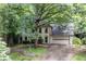 Charming two-story home with a well-manicured lawn and mature trees enhancing its curb appeal at 735 Wood Valley Trce, Roswell, GA 30076