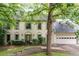 Charming two-story home featuring a well-manicured lawn and traditional architectural details at 735 Wood Valley Trce, Roswell, GA 30076