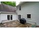 Exterior view of the home with brick patio, grill, and neutral siding at 735 Wood Valley Trce, Roswell, GA 30076