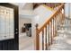 Inviting foyer with wood staircase, decorative door, and tile flooring at 735 Wood Valley Trce, Roswell, GA 30076