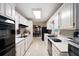 Spacious kitchen with ample counter space, white cabinets, and modern appliances at 735 Wood Valley Trce, Roswell, GA 30076