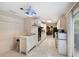 Bright kitchen with white cabinetry, tile floors, and unique hanging light fixture at 735 Wood Valley Trce, Roswell, GA 30076