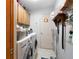 Functional laundry room with ample storage and modern washer and dryer at 735 Wood Valley Trce, Roswell, GA 30076