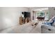 Cozy living room with plush carpet, television, and an adjacent dining space at 735 Wood Valley Trce, Roswell, GA 30076