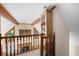 Loft area overlooking the living room with a wooden banister and decorative accents at 735 Wood Valley Trce, Roswell, GA 30076
