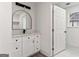 Bright bathroom featuring a modern vanity, stylish mirror, and fresh white finishes at 819 Humphries St, Atlanta, GA 30310