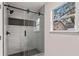 Modern bathroom with glass enclosed shower and a window at 819 Humphries St, Atlanta, GA 30310