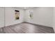 This cozy bedroom offers new gray floors, white walls, natural light from two windows, and a door for easy access at 819 Humphries St, Atlanta, GA 30310