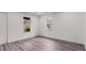 This cozy bedroom features modern gray laminate flooring and white walls with natural light from two windows at 819 Humphries St, Atlanta, GA 30310