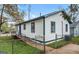 Charming home featuring white siding, blue trim, a fenced yard, and a small ramp leading to the entrance at 819 Humphries St, Atlanta, GA 30310