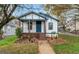 Charming home featuring a covered porch, freshly painted exterior, and a well-manicured front yard at 819 Humphries St, Atlanta, GA 30310