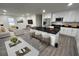 Open-concept kitchen features a center island with seating, stainless appliances and a view of the living area at 819 Humphries St, Atlanta, GA 30310