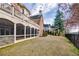 Spacious backyard with manicured lawn, covered patio, and mature landscaping for outdoor enjoyment at 2760 Sugarloaf Club Dr, Duluth, GA 30097