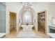 Stunning bathroom with a soaking tub under an arched window and a frameless glass shower enclosure at 2760 Sugarloaf Club Dr, Duluth, GA 30097