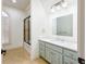 Bathroom featuring a shower-tub combo, white cabinets, and a large mirror at 2760 Sugarloaf Club Dr, Duluth, GA 30097