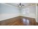 Bedroom with blue walls, hardwood floors, white trim, and a ceiling fan at 2760 Sugarloaf Club Dr, Duluth, GA 30097