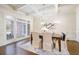 Formal dining room with coffered ceilings, hardwood floors, elegant chandelier, and large windows at 2760 Sugarloaf Club Dr, Duluth, GA 30097