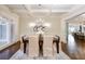 Formal dining room with coffered ceilings, hardwood floors, elegant chandelier, and abundant light at 2760 Sugarloaf Club Dr, Duluth, GA 30097