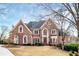 Charming two-story brick home with landscaped yard, gabled roof, and an inviting entrance at 2760 Sugarloaf Club Dr, Duluth, GA 30097