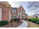 Stunning brick home with a grand entrance, lush landscaping, and a welcoming walkway at 2760 Sugarloaf Club Dr, Duluth, GA 30097