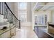 Grand foyer with high ceilings, decorative staircase, and elegant tile flooring, showcasing refined elegance at 2760 Sugarloaf Club Dr, Duluth, GA 30097
