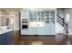 Kitchen showcasing custom cabinets, stainless steel appliances, granite counters and easy access to an elegant staircase at 2760 Sugarloaf Club Dr, Duluth, GA 30097