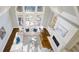 Bright and airy living room with hardwood floors, white sofas, a fireplace, and oversized windows at 2760 Sugarloaf Club Dr, Duluth, GA 30097