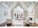 Bright living room with vaulted ceilings, fireplace, and large windows overlooking the backyard at 2760 Sugarloaf Club Dr, Duluth, GA 30097