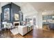 Bright living room featuring a fireplace, high ceilings, hardwood floors, and large windows overlooking the backyard at 2760 Sugarloaf Club Dr, Duluth, GA 30097