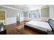 Main bedroom with hardwood floors, a bay window, and an ensuite bathroom at 2760 Sugarloaf Club Dr, Duluth, GA 30097