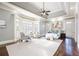 Spacious main bedroom features a tray ceiling, a sitting area, hardwood floors, and large bay windows at 2760 Sugarloaf Club Dr, Duluth, GA 30097