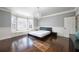 Bright main bedroom featuring hardwood floors, elegant chandelier, and a bay window with built-in bench at 2760 Sugarloaf Club Dr, Duluth, GA 30097