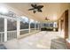 Relaxing covered patio featuring ceiling fans, an outdoor kitchen, and tile flooring at 2760 Sugarloaf Club Dr, Duluth, GA 30097