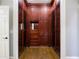 Spacious walk-in closet features custom wood cabinetry, drawers, and glass display cases at 2760 Sugarloaf Club Dr, Duluth, GA 30097