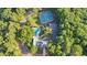 Aerial view showcasing community pool, tennis courts, clubhouse, and mature landscaping at 3875 Sweetwater Dr, Cumming, GA 30041